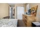 Bedroom with carpet, a window, neutral walls, and view into the laundry area at 8180 Washington St # 126, Denver, CO 80229