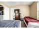 Bedroom featuring carpet, a view into the laundry, and a large bed at 8180 Washington St # 126, Denver, CO 80229