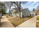 Two-story home showcasing a covered porch, well-maintained yard, and mature trees at 8180 Washington St # 126, Denver, CO 80229