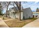 Two-story home showcasing a covered porch, well-maintained yard, and mature trees at 8180 Washington St # 126, Denver, CO 80229