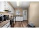 Efficient kitchen with white cabinets, and essential appliances at 8180 Washington St # 126, Denver, CO 80229