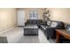 Bright living room features modern floors, black sofas and neutral paint at 8180 Washington St # 126, Denver, CO 80229