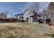 Wide shot of the large fenced yard featuring a patio with a wood pergola at 2888 Deer Creek Trl, Highlands Ranch, CO 80129