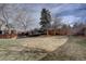 Large fenced backyard with a well-maintained lawn, mature trees, and a trampoline at 2888 Deer Creek Trl, Highlands Ranch, CO 80129