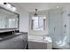 Elegant bathroom with soaking tub, glass shower, and stylish vanity at 2888 Deer Creek Trl, Highlands Ranch, CO 80129