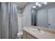 This traditional bathroom features a shower-tub combo with neutral tiling and a single sink vanity at 2888 Deer Creek Trl, Highlands Ranch, CO 80129