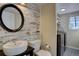 Compact half bathroom showcasing rustic wood wall and modern fixtures at 2888 Deer Creek Trl, Highlands Ranch, CO 80129