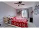 This bedroom showcases a ceiling fan and a window for natural light at 2888 Deer Creek Trl, Highlands Ranch, CO 80129