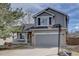 Charming two-story home with a well-manicured lawn and an attached two-car garage at 2888 Deer Creek Trl, Highlands Ranch, CO 80129