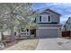 Charming two-story home with a well-manicured lawn and an attached two-car garage at 2888 Deer Creek Trl, Highlands Ranch, CO 80129