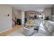 Comfortable living room with a glimpse into a modern kitchen and staircase at 2888 Deer Creek Trl, Highlands Ranch, CO 80129