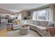 Bright and open living area with kitchen view, large window, and modern decor at 2888 Deer Creek Trl, Highlands Ranch, CO 80129