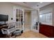 Bright home office featuring french doors, wood floors, a sleek desk and modern chair at 2888 Deer Creek Trl, Highlands Ranch, CO 80129