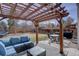 Inviting patio with a wood pergola, outdoor seating, a dining table and a grill at 2888 Deer Creek Trl, Highlands Ranch, CO 80129