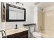 Traditional bathroom with a framed mirror, tile flooring, and shower-tub combination at 2575 S Syracuse Way # M307, Denver, CO 80231