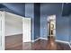Bright bedroom features hardwood floors and ensuite access to the bathroom at 2575 S Syracuse Way # M307, Denver, CO 80231