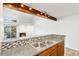 Kitchen with granite countertops, decorative tile backsplash, and modern track lighting at 2575 S Syracuse Way # M307, Denver, CO 80231