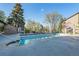 A partially visible pool and deck surrounded by trees and grass at 2575 S Syracuse Way # M307, Denver, CO 80231