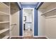 Spacious walk-in closet offers ample storage with rods and shelving with bathroom access at 2575 S Syracuse Way # M307, Denver, CO 80231