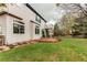 Large backyard featuring a grassy lawn, mature trees, a stone patio, and partial fencing at 6647 Lynx Cv, Lone Tree, CO 80124