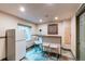 The basement wet bar has tile flooring and white cabinets at 6647 Lynx Cv, Lone Tree, CO 80124