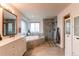 Luxurious primary bathroom featuring a soaking tub and glass-enclosed shower at 6647 Lynx Cv, Lone Tree, CO 80124