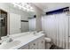 Bathroom featuring a double vanity, white cabinets, and a shower curtain at 6647 Lynx Cv, Lone Tree, CO 80124