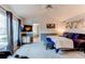 Comfortable bedroom with vaulted ceilings, large windows, and ensuite bath at 6647 Lynx Cv, Lone Tree, CO 80124