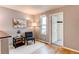 Cozy bedroom featuring wood floors, a reading nook with natural light, and stylish decor with a peaceful ambiance at 6647 Lynx Cv, Lone Tree, CO 80124