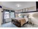 Comfortable bedroom with soft carpet, good lighting, and decorative pillows on the bed at 6647 Lynx Cv, Lone Tree, CO 80124
