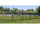 Community pool with many seats, mature trees and grass at 6647 Lynx Cv, Lone Tree, CO 80124