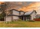 Inviting two-story home with a manicured lawn, lush landscaping, and solar panels on the roof at 6647 Lynx Cv, Lone Tree, CO 80124