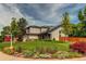 Charming two-story home featuring a manicured lawn, solar panels, and beautiful landscaping at 6647 Lynx Cv, Lone Tree, CO 80124
