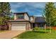 Charming two-story home with a brick-accented garage and a well-maintained front lawn at 6647 Lynx Cv, Lone Tree, CO 80124