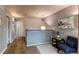 Hallway with hardwood floors and a comfortable chair next to a small table at 6647 Lynx Cv, Lone Tree, CO 80124