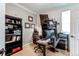 Functional home office featuring a desk, chair, shelving, and multiple computer monitors setup at 6647 Lynx Cv, Lone Tree, CO 80124