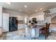 Kitchen with white cabinetry, stainless steel appliances, and tile floors with a kitchen island at 6647 Lynx Cv, Lone Tree, CO 80124