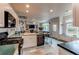 Open kitchen with white cabinets, slate tile floors, and an island overlooking the living area at 6647 Lynx Cv, Lone Tree, CO 80124