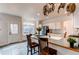Bright kitchen with an eat-in island, updated appliances, and plenty of natural light from the adjacent doorway at 6647 Lynx Cv, Lone Tree, CO 80124