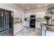 Well-equipped kitchen with stainless steel appliances, white cabinets, and functional layout at 6647 Lynx Cv, Lone Tree, CO 80124