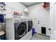 Well-organized laundry room with side-by-side washer and dryer and shelving for storage at 6647 Lynx Cv, Lone Tree, CO 80124