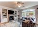 Cozy living room with fireplace, built-in shelves, a large window and a comfortable couch at 6647 Lynx Cv, Lone Tree, CO 80124