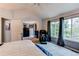 Spacious main bedroom with a high ceiling, carpet, large windows and an additional room with dresser at 6647 Lynx Cv, Lone Tree, CO 80124