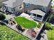 Aerial view of a home with a well-manicured lawn, covered porch and outdoor living spaces at 6193 Saddle Bow Ave, Parker, CO 80134