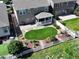 Aerial view of a home with manicured backyard, stone patio and covered porch perfect for outdoor living at 6193 Saddle Bow Ave, Parker, CO 80134
