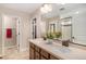 Modern bathroom with double sinks, quartz counters, and a glass-enclosed shower at 6193 Saddle Bow Ave, Parker, CO 80134