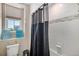 Cozy bathroom with gray tiling, a shower curtain, and bright window at 6193 Saddle Bow Ave, Parker, CO 80134