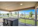 Relaxing covered porch with an outdoor dining set, offering scenic views of the surrounding green space at 6193 Saddle Bow Ave, Parker, CO 80134