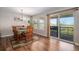 Elegant dining room with hardwood floors, table with six chairs and a sliding glass door to a patio at 6193 Saddle Bow Ave, Parker, CO 80134