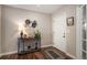 Front entryway with hardwood floors, a decorated console table, artwork and a large white door at 6193 Saddle Bow Ave, Parker, CO 80134